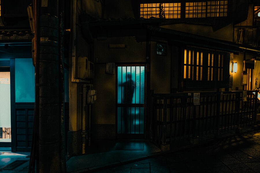 Facciata di una machiya con finestre illuminate di blu, Kyoto