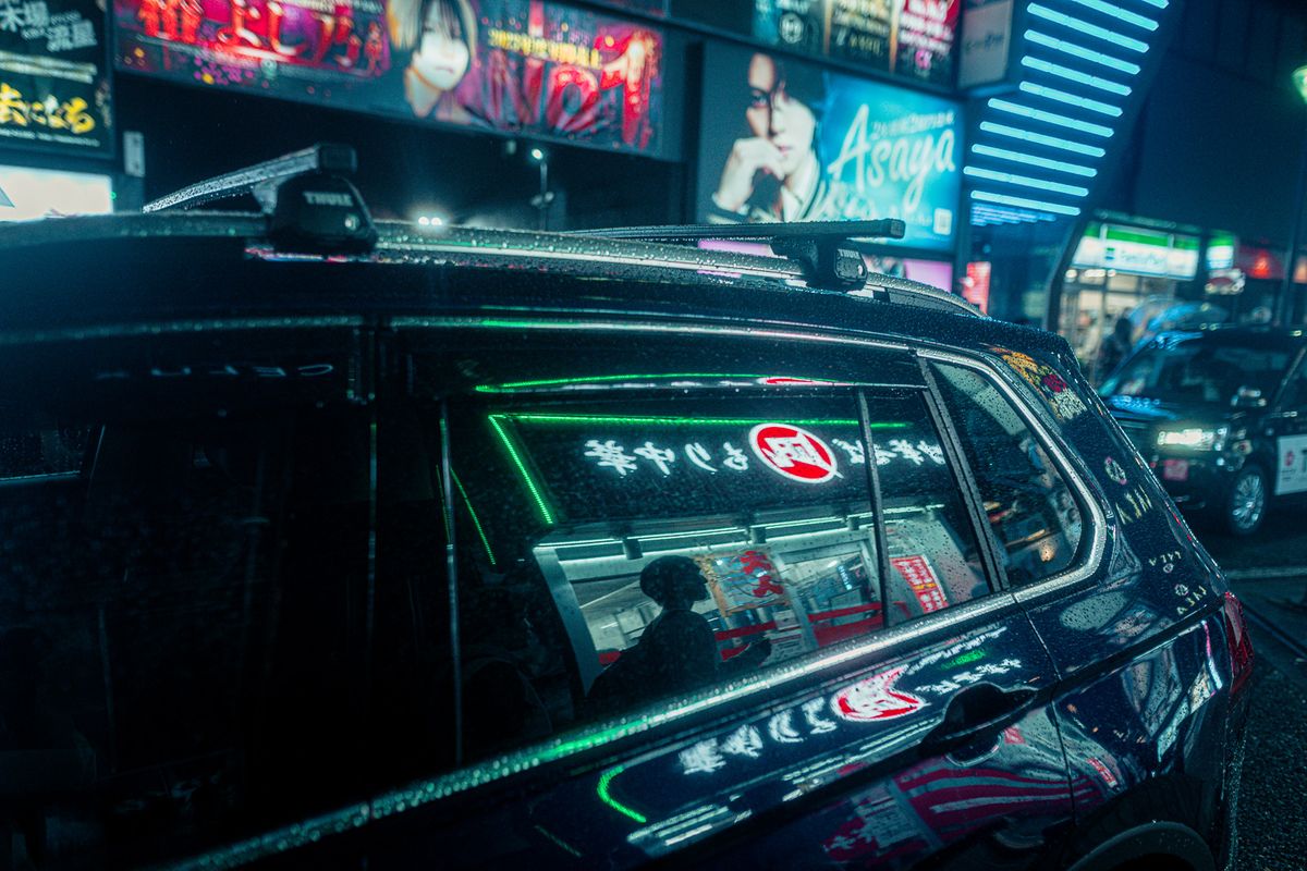 Insegne verdi riflesse sul finestrino bagnato di un’auto, Kabukichō, Tokyo